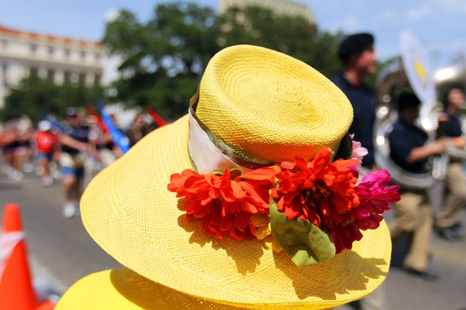 A member of the Battle of Flowers Association judges high school bands as they pass in front of the Alamo during the Fiesta Battle of Flowers Parade, Friday, April 27, 2012. (JENNIFER WHITNEY for the San Antonio Express-News)